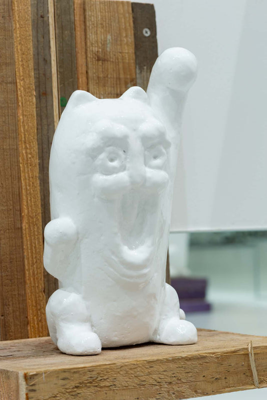A standing cat statue that continues to invite all connections